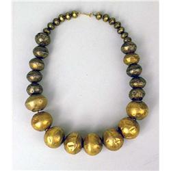 A MIDDLE EASTERN GOLD TONE BEADED NECKLACE