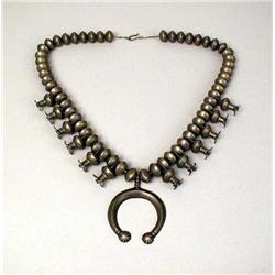 AN OLD NAVAJO HAND WROUGHT SILVER SQUASH BLOSSOM NECKLACE