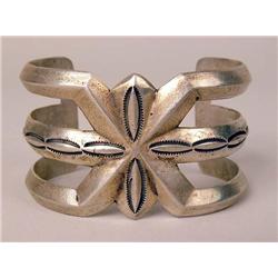 AN OLD SIGNED NAVAJO HAND WROUGHT SILVER SAND CAST CUFF BRACELET