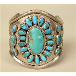 AN OLD HEAVY NAVAJO HAND WROUGHT SILVER AND TURQUOISE CUFF BRACELET
