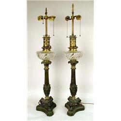A PAIR OF CAST IRON AND GLASS OIL LAMPS
