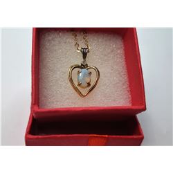 8)  GOLD TONE HEART PENDANT WITH OVAL