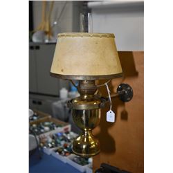 Wall mount brass ships lamp in swivelling mount with clear hurricane and paper shade, 14  in height