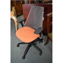 Quality Sayl office chair designed by Yves Behar for Herman Miller with black base and tomato seat