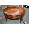 Image 1 : Modern 40" diameter four drawer coffee table with matched grain top and brass castors