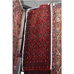 100% handmade scatter rug with red background and geometric design with highlights of pink, blue etc