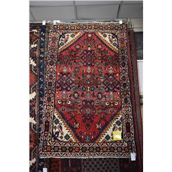 100% handmade wool carpet Hamdan with overall geometric design and highlights of red, cream, orange 