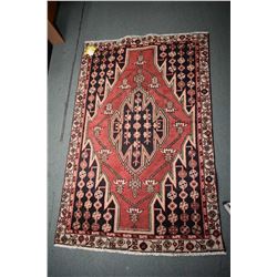 100% handmade wool Mazlegan carpet with center medallion, red background and highlights of blue and 