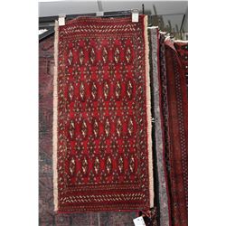 100% handmade wool scatter rug with red background and fringing 18" X 38"