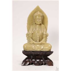 Green soapstone carved Buddha on a dark stone base, 7 3/4" in height