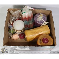 A BOX OF CANDLEHOLDERS WITH CANDLES