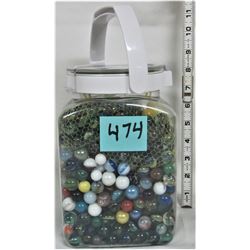 Plastic jar full of marbles, assortment