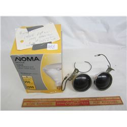 Pair of purple lights, used to shine on the inside of windshield at night to reduce glare. Some peop