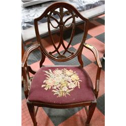 ANTIQUE WOODEN ARM CHAIR WITH CARVED BACK AND