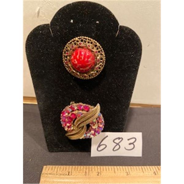 pair of red brooches