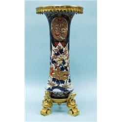 An antique Imari porcelain vase, hand painted with iron red 