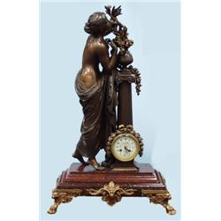 An unusual antique French figural mantle clock. The circular