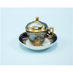 An 18th century porcelain cup and saucer with cover. Hand pa