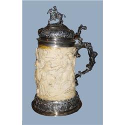 An early 19th century German carved ivory and silver tankard