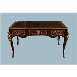 A Louis XV style library desk with gilt bronze patinated mou