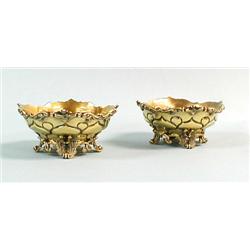 A pair of English gilt sterling silver salts with relief scr