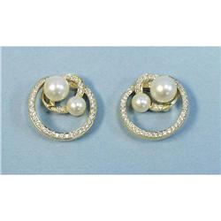 A pair of 18 kt. yellow gold, diamond and pearl earrings. Ea