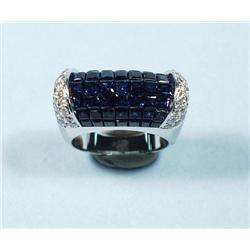 An 18 kt. white gold, sapphire and diamond ring. Seven rows 