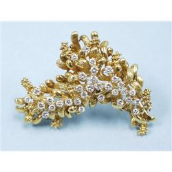 An 18 kt. gold and diamond pendant brooch in form of a bough