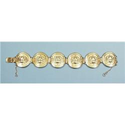 An attractive 18 kt. gold bracelet designed of 6 medallions,