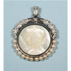 A circular platinum, diamond and pearl pendant with a mother