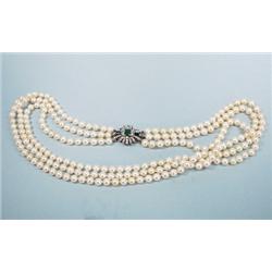 A 26" long triple stranded cultured pearl necklace, 7.5-7 mm
