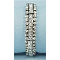 A hand made lady's platinum and diamond bracelet set with a 