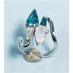 A hand made platinum, emerald and diamond ring of contempora