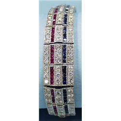 A platinum, diamond, sapphire and ruby bracelet. Mounted wit