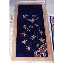 A semi-antique Chinese rug with bird and bamboo decoration. 