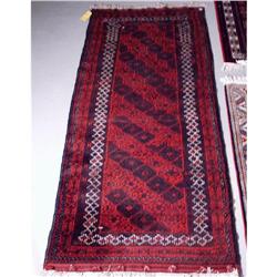 A Beluchi wool runner. Approx. size: 7'2" x 3'1".