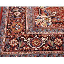 A semi-antique Persian Heriz carpet. Approx. size: 14' X 11'