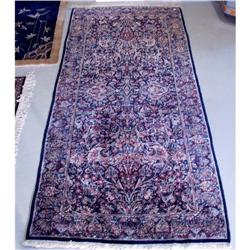 A Persian Kerman wool runner. Approx. size: 9' x 3'10".