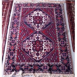 A Persian Afshari wool rug. Approx. size: 5'8" x 4'.