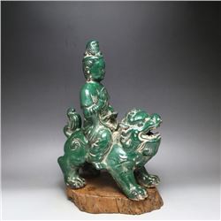 A GREEN PORCELAIN BUDDHA FIGURE MING DYNASTY.