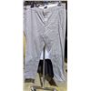 Image 4 : A rack of pants including dress pants and cargo pants