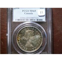 1958 $1 PCGS MS65.  Rare and popular Elizabeth silver dollar in MS65.  Fantastic rainbow toning.