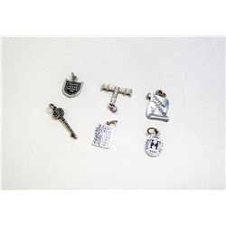 LOT OF SEVEN ASSORTED SILVER TONE CHARMS