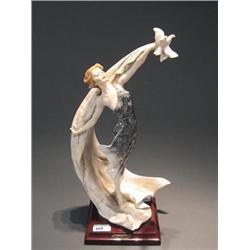 Guiseppe Armani cast resin figure of a woman wearing a flowing dress and holding a dove.  Marked 199