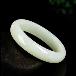 A NATURAL WHITE JADE BANGLE.
