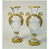 Image 1 : A PAIR OF NEOCLASSICAL STYLE ORMOLU-MOUNTED COLORLESS GLASS DOUBLE-HANDLED URNS