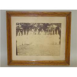 FRAMED MOUNTED PHOTOGRAPH OF A FRATERNAL GROUP IN WHITE DUNC