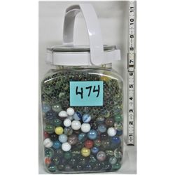 Plastic jar full of marbles, assortment