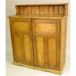 A PROVINCIAL OAK AND PINE TWO DOOR SERVING CABINET