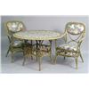 Image 1 : A POLYCHROME RATTAN AND FLORAL UPHOLSTERED CIRCULAR BREAKFAST TABLE